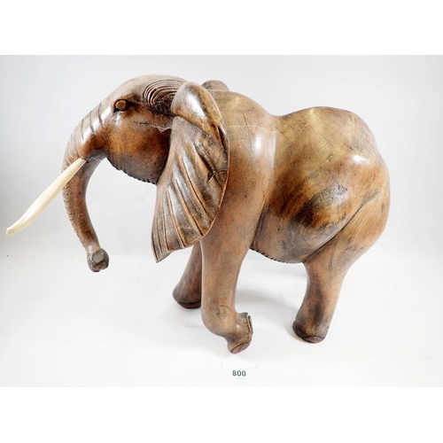 800 - A large carved African elephant with simulated ivory tusks, 32cm tall