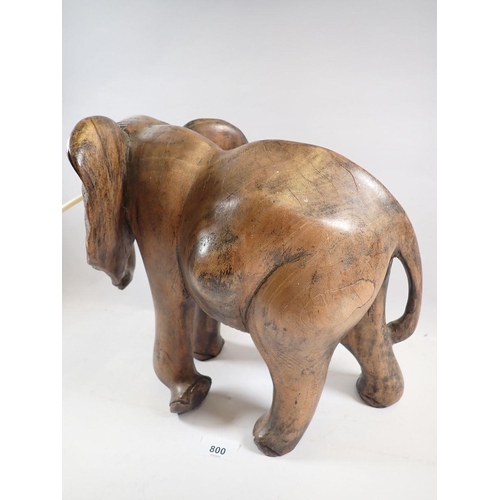 800 - A large carved African elephant with simulated ivory tusks, 32cm tall