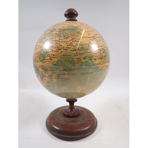 801 - A vintage small globe, 22cm tall