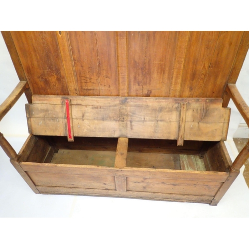 803 - An antique pine panelled settle, 140cm wide