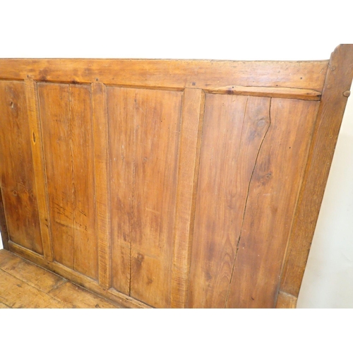 803 - An antique pine panelled settle, 140cm wide