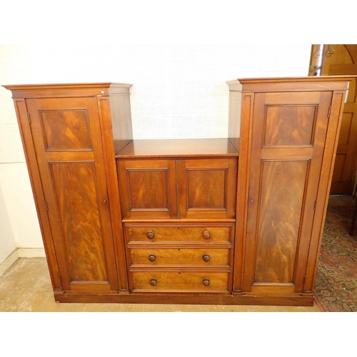 819 - A Victorian mahogany wardrobe and linen press with two hanging compartments flanking three drawers a... 