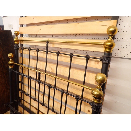 833 - A Victorian 4ft brass and iron double bed with brass finials