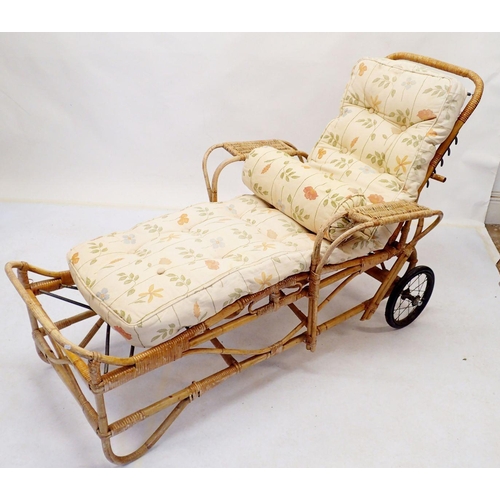 834 - An early 20th century wicker garden sun lounger with wheels and later cushion