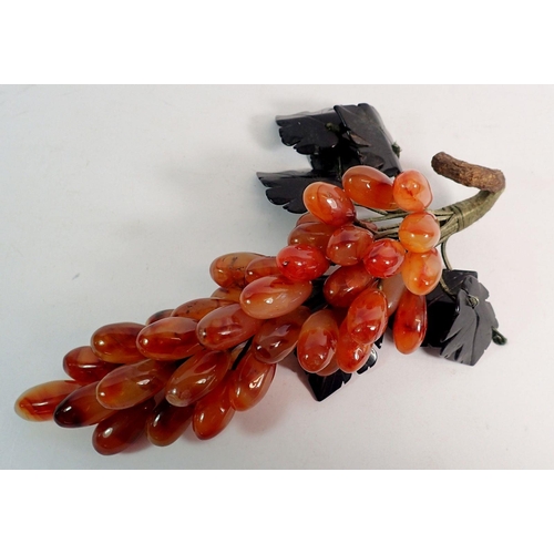 844 - A carved stone bunch of grapes, 26cm