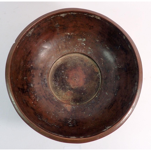 871 - An antique bronze bowl with cast band of decoration to outer rim, 24cm diameter