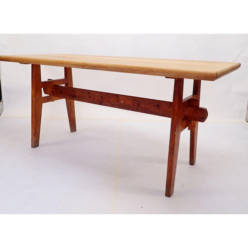 875 - A farmhouse style pine dining table on trestle style ends, 160 x 70cm x 73cm high