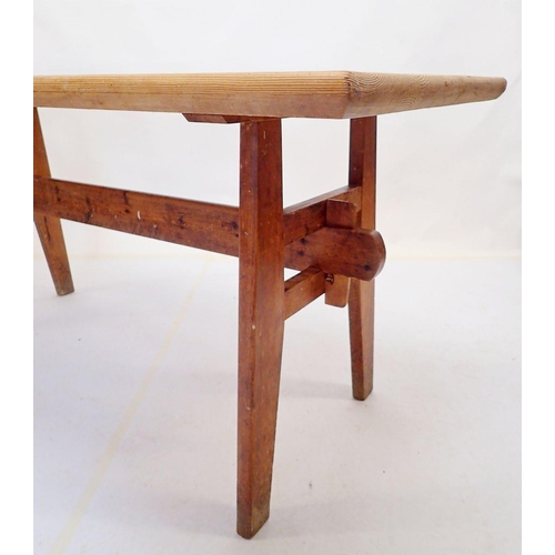 875 - A farmhouse style pine dining table on trestle style ends, 160 x 70cm x 73cm high