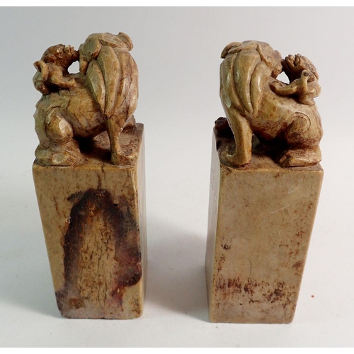 895 - A large pair of Qing Dynasty Chinese stone seals carved Foo dogs to tops and script, 18cm