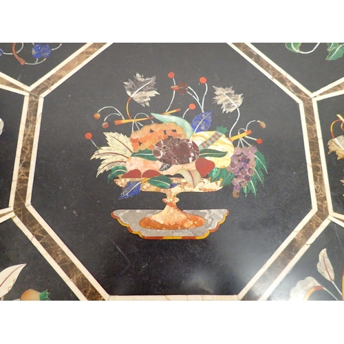 973 - A 20th century pietra dura octagonal table top decorated fruit on a black ground, 76cm diameter