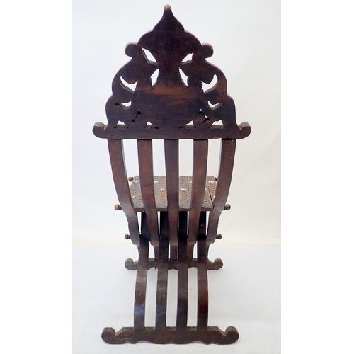 976 - An Islamic teak and mother of pearl folding chair with carved script