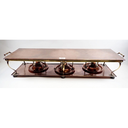 977 - An Edwardian copper and brass hot plate with three spirit burners