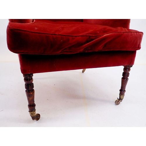 988 - A late Georgian wing armchair on slender turned supports