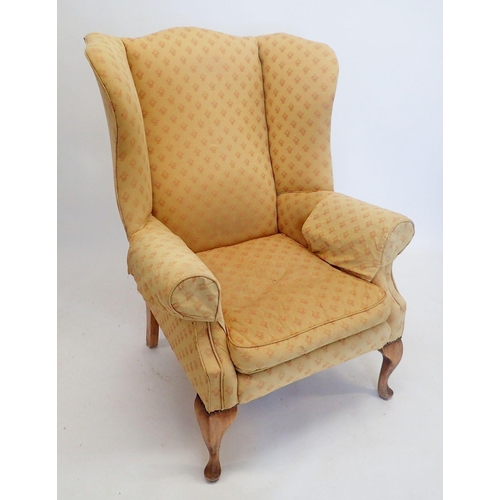 1285 - A wing armchair on cabriole supports