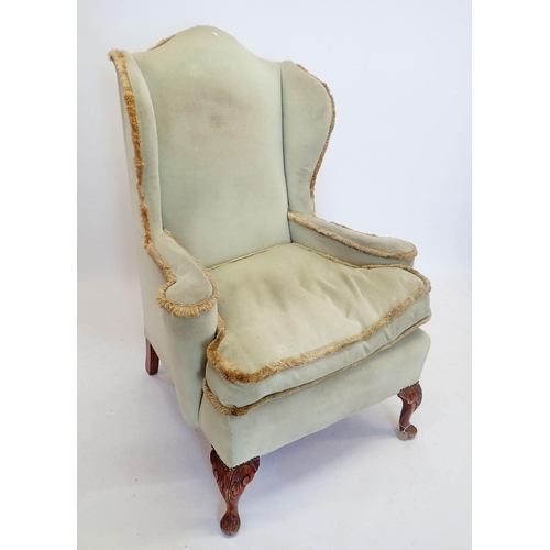 1288 - An early 20th century wing armchair on carved cabriole supports