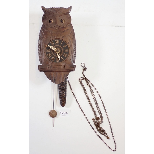 1294 - A Black Forrest owl form carved wood clock with moving eyes, 20cm tall