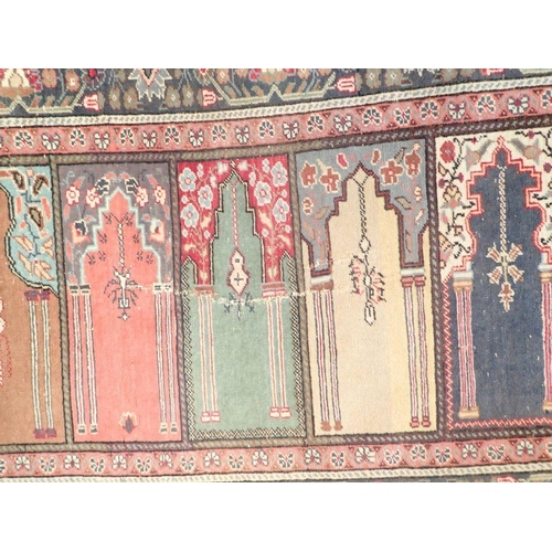 1300 - A Persian family prayer rug with five arched panels, 217 x 92cm