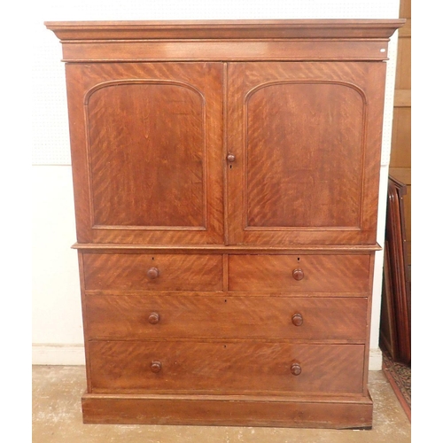 1307 - A 19th century mahogany small linen press with two arch panelled doors enclosing trays all over two ... 