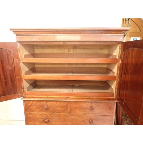 1307 - A 19th century mahogany small linen press with two arch panelled doors enclosing trays all over two ... 