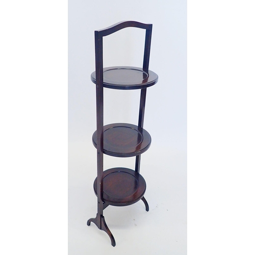 1318 - A folding three tier mahogany cake stand