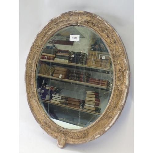 1328 - A Georgian gilt framed oval mirror moulded foliate sprays, 50 x 43cm