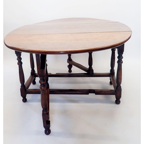 1332 - An 18th century oak drop-leaf dining table on turned supports, 123 x 175cm