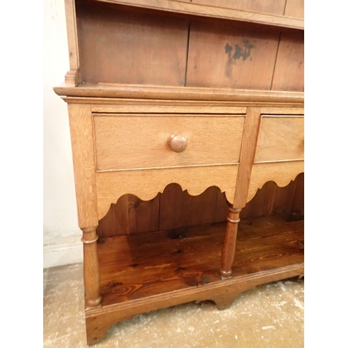 1336 - A 19th century oak and pine Welsh dresser with three tier back over three drawers, shaped apron and ... 