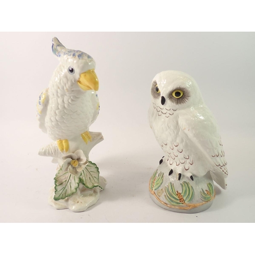 140 - A Crown Staffordshire snowy owl by Linley Adams 19cm high, a parakeet marked Italy, a Beswick lion c... 