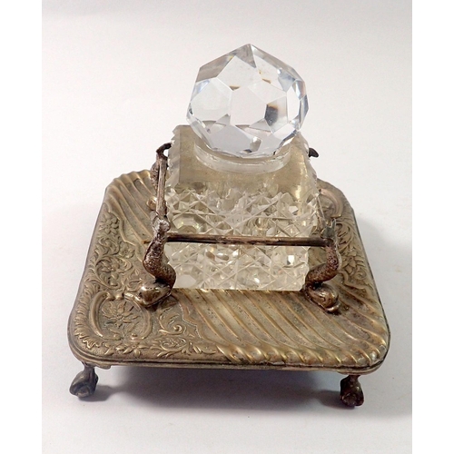 254 - A cut glass inkwell in silver plated stand with dolphin supports, 11 x 13cm