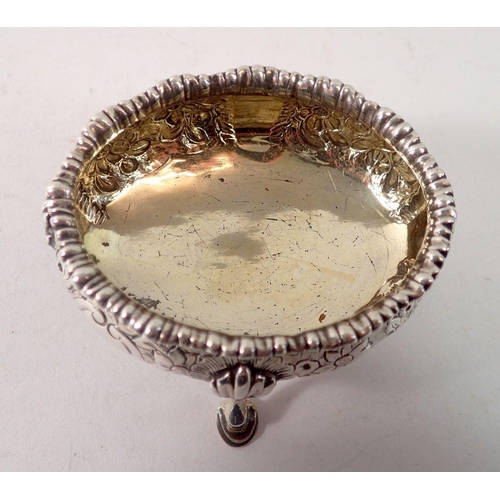 346 - A George III silver oval salt on four hoof feet with embossed floral and scroll decoration, London 1... 