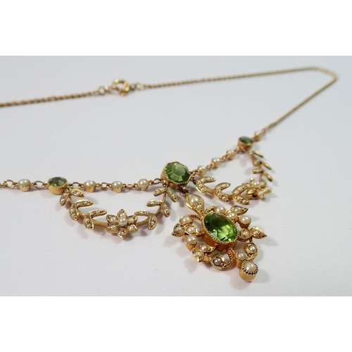 391 - An Edwardian 15ct gold necklace set peridots with seed pearl set flower and leaf surrounds, 11.3g, (... 