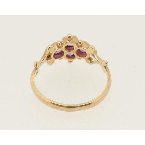 415 - An antique style 9 carat gold ring set four amethysts in scrollwork and beaded surround, 1.6g, size ... 