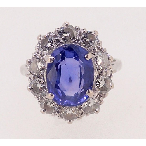 424 - A fine Ceylon sapphire and diamond cluster ring, the sapphire 11mm x 8mm, ring size O, 4.8g