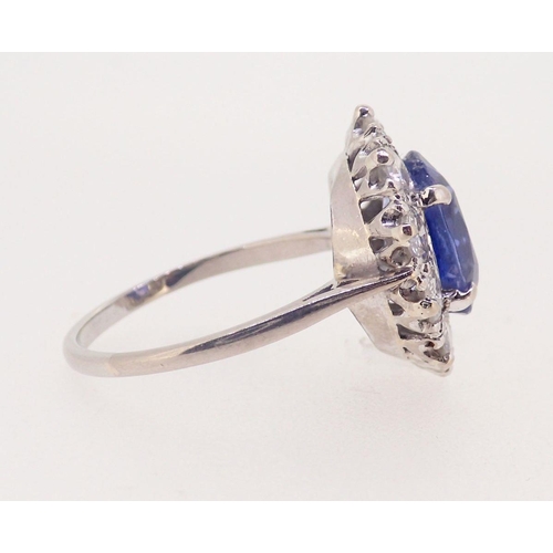 424 - A fine Ceylon sapphire and diamond cluster ring, the sapphire 11mm x 8mm, ring size O, 4.8g