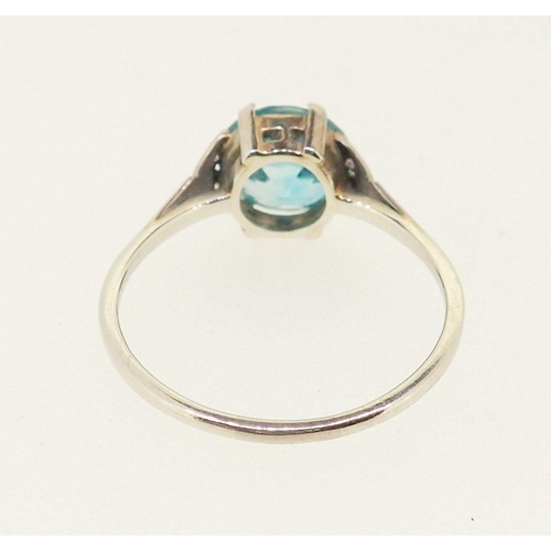 434 - An 18 carat white gold ring set blue zircon on diamond chip shoulders, size P-Q, 2.6g