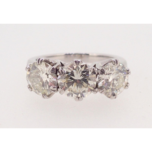 437 - A fine platinum set three stone diamond ring - approximately three carats in total, 7.8g