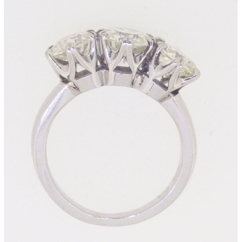 437 - A fine platinum set three stone diamond ring - approximately three carats in total, 7.8g