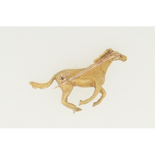 463 - A 9 carat gold brooch in the from of a galloping horse, 8.9g, 3.7cm wide