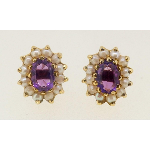 466 - A pair of 9 carat gold earrings set amethysts and seed pearls