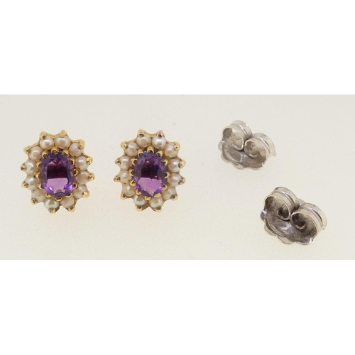 466 - A pair of 9 carat gold earrings set amethysts and seed pearls