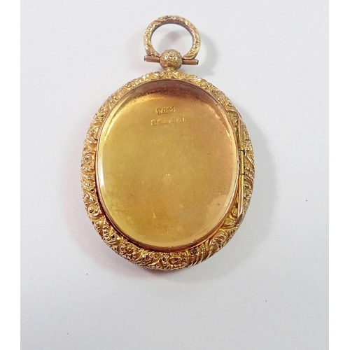 477 - A Victorian 9 carat gold oval locket with engraved decoration and glazed to verso, 9g, 4 x 3.3cm