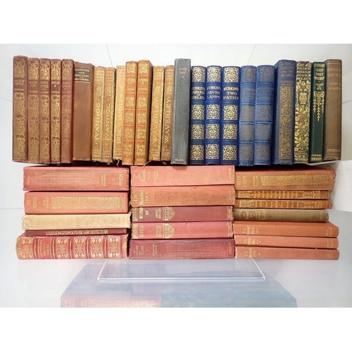 715 - A box of literary books including some leather bindings and works by Ruskin, Thackeray etc.