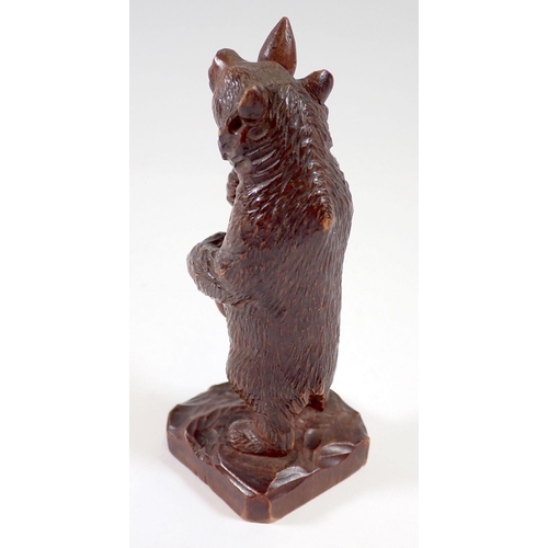 824 - A Black Forrest carved wood bear with club, 12cm tall