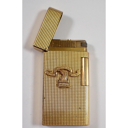 834 - A Caran D'ache gold plated lighter with applied crest