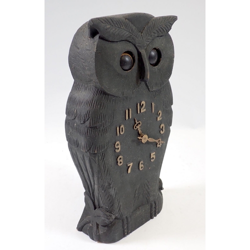 944 - A 20th century Black Forrest carved wooden owl form clock with oscillating eyes, 24.5cm