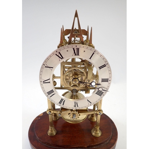 945 - A 19th century skeleton clock with steeple movement and matched glass dome, 29cm tall