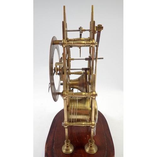 945 - A 19th century skeleton clock with steeple movement and matched glass dome, 29cm tall