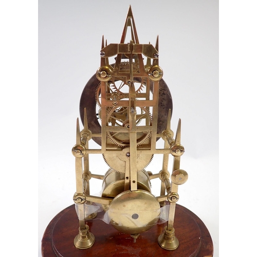 945 - A 19th century skeleton clock with steeple movement and matched glass dome, 29cm tall