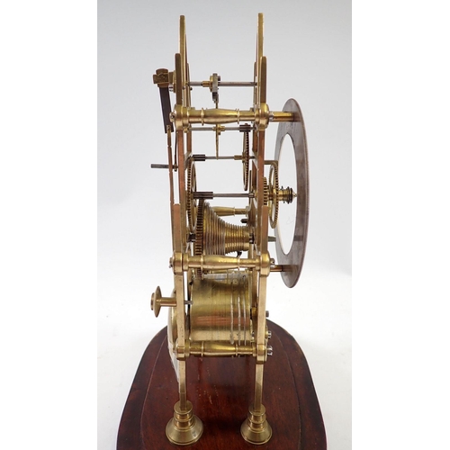 945 - A 19th century skeleton clock with steeple movement and matched glass dome, 29cm tall