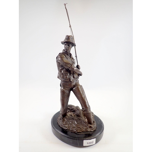 1002 - A bronze finish figure of a fisherman after Milo on marble base, 41cm tall